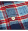 Thumbnail Close-up of chest pocket flap with button on blue plaid.