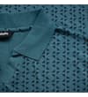 Thumbnail Close-up of collar and shoulder on petrol geometric polo.