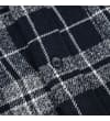 Thumbnail Close-up of navy button on checked flannel fabric.