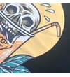 Thumbnail Close-up of skull cocktail print with straw and yellow circle.