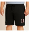 Thumbnail Black basketball shorts worn front view with 11 graphic.