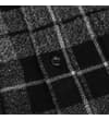 Thumbnail Close-up of the button placket on the checked flannel shirt.