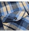 Thumbnail Close-up of chest pocket flap with button on checked shirt.