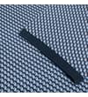 Thumbnail Close-up of split hem detail on navy geometric polo.