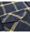 Thumbnail Close-up of a chest pocket flap with button on the checked shirt.