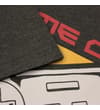 Thumbnail Close-up of sleeve seam and front graphic on charcoal tee.