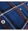 Thumbnail Close-up of blue check shirt pocket seam and buttons.