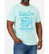 Thumbnail Model wearing mint green T-shirt with blue surfing camp print.