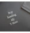 Thumbnail Angled close-up of embroidered slogan and sleeve on tee.