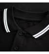 Thumbnail Close-up of black polo collar with white tipped trim.