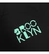 Thumbnail Close-up of the small Brooklyn chest print on black T-shirt.