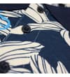 Thumbnail Close-up of navy floral polo placket and buttons.