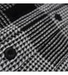 Thumbnail Close-up of checked shirt fabric with black button detail.
