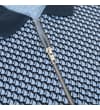 Thumbnail Close-up of silver zip placket on geometric print polo.
