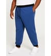 Thumbnail Model wearing deep blue joggers in angled side view.