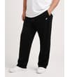 Thumbnail Black open hem sweatpants worn with white trainers.