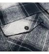 Thumbnail Close-up of chest pocket flap on grey checked flannel shirt.