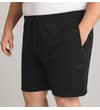 Thumbnail Black fleece shorts worn, angled view with zipped side pockets.